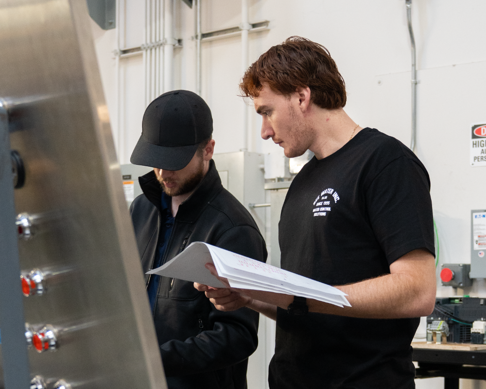 Two men quality checking a panel.