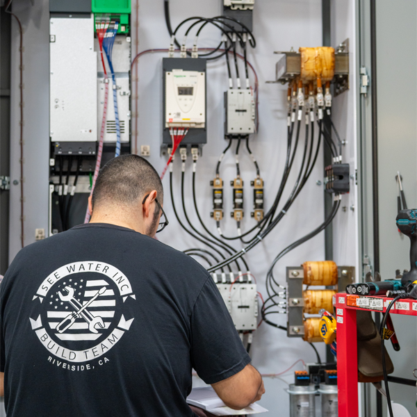 Man working on custom control panel.