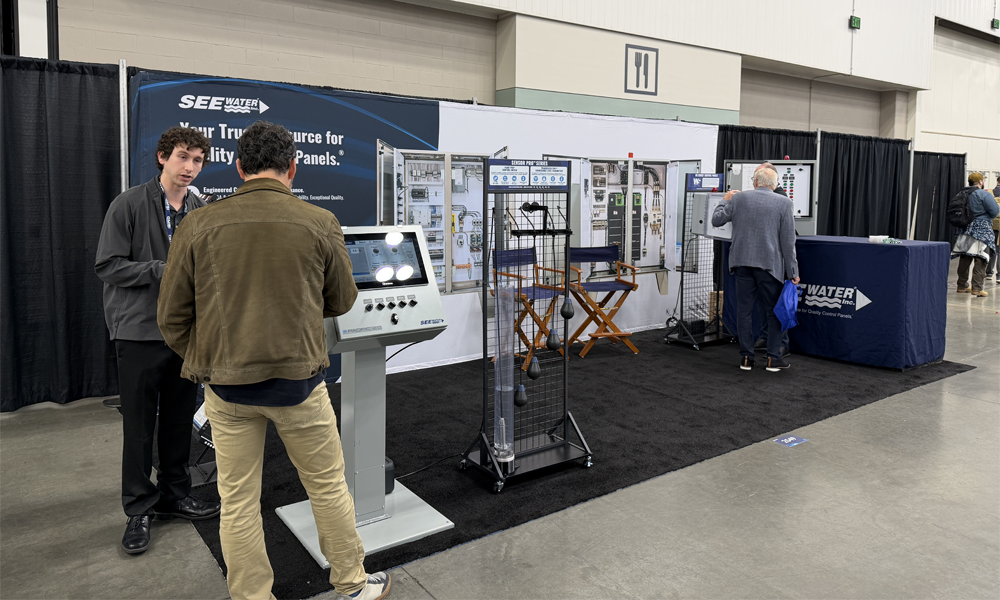 Two men talking at tradeshow booth.
