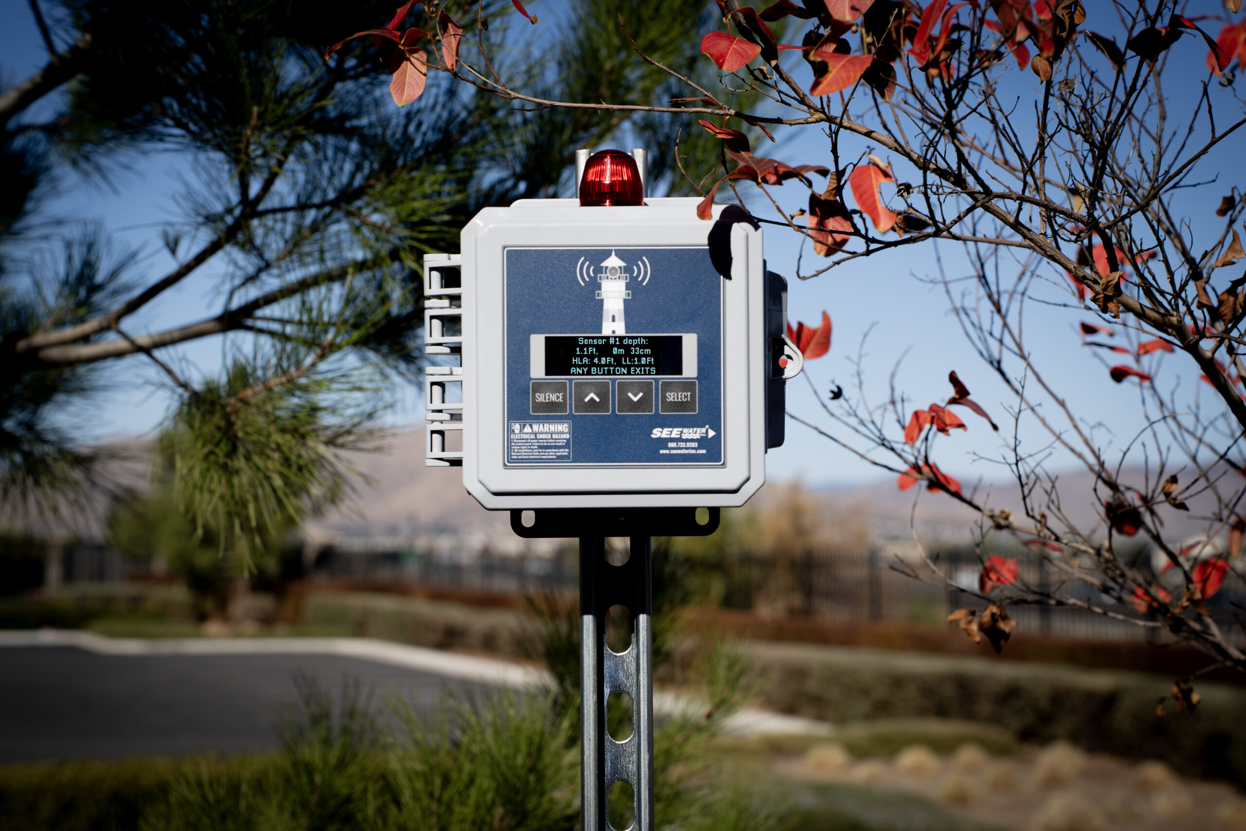 Home Lighthouse™ Liquid Level Alarm surrounded by trees.